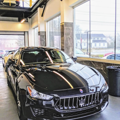 Black Maserati in car port