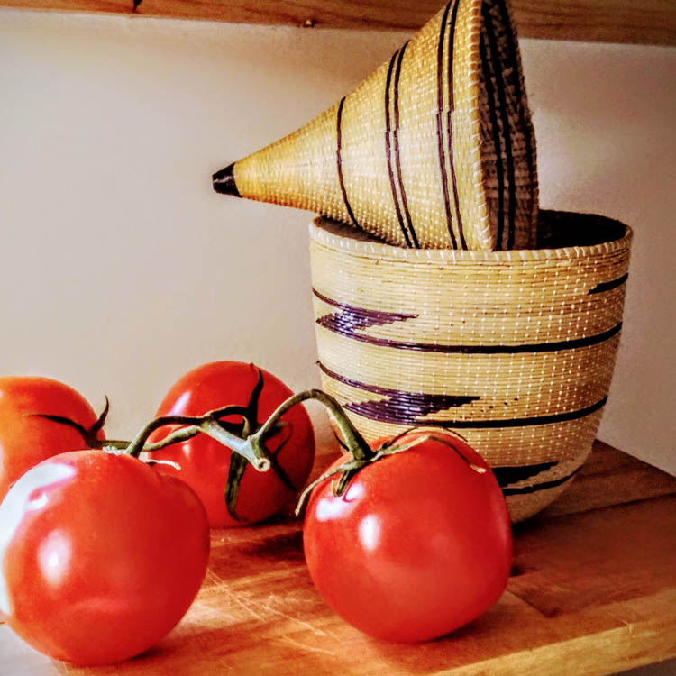 African woven basket with locally grown tomatoes