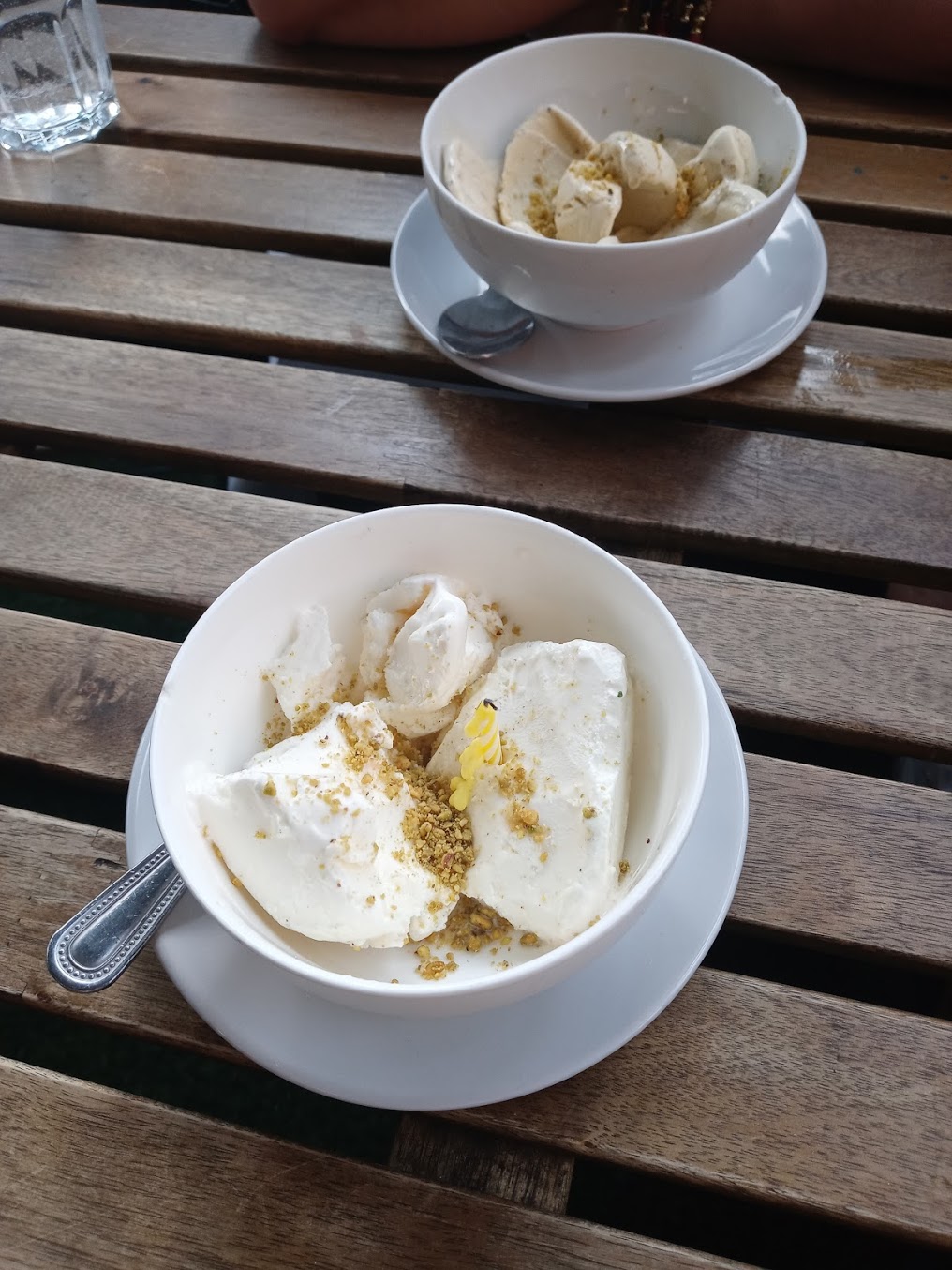 Bowls of ice cream on a wooden table