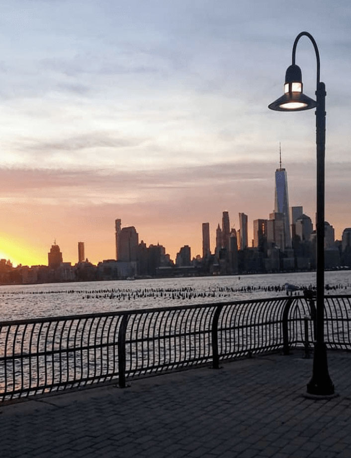 Lamppost in front of lower Manhattan sunrise