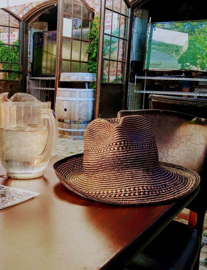 Hat resting on a long table at a biergarten