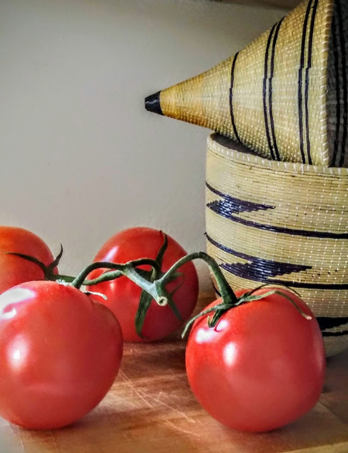 Woven African basket with fresh tomatoes