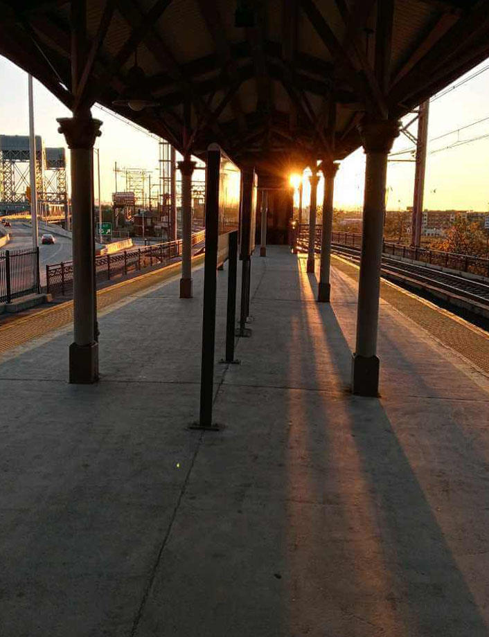 Shadow and light created by sunrise on a train platform