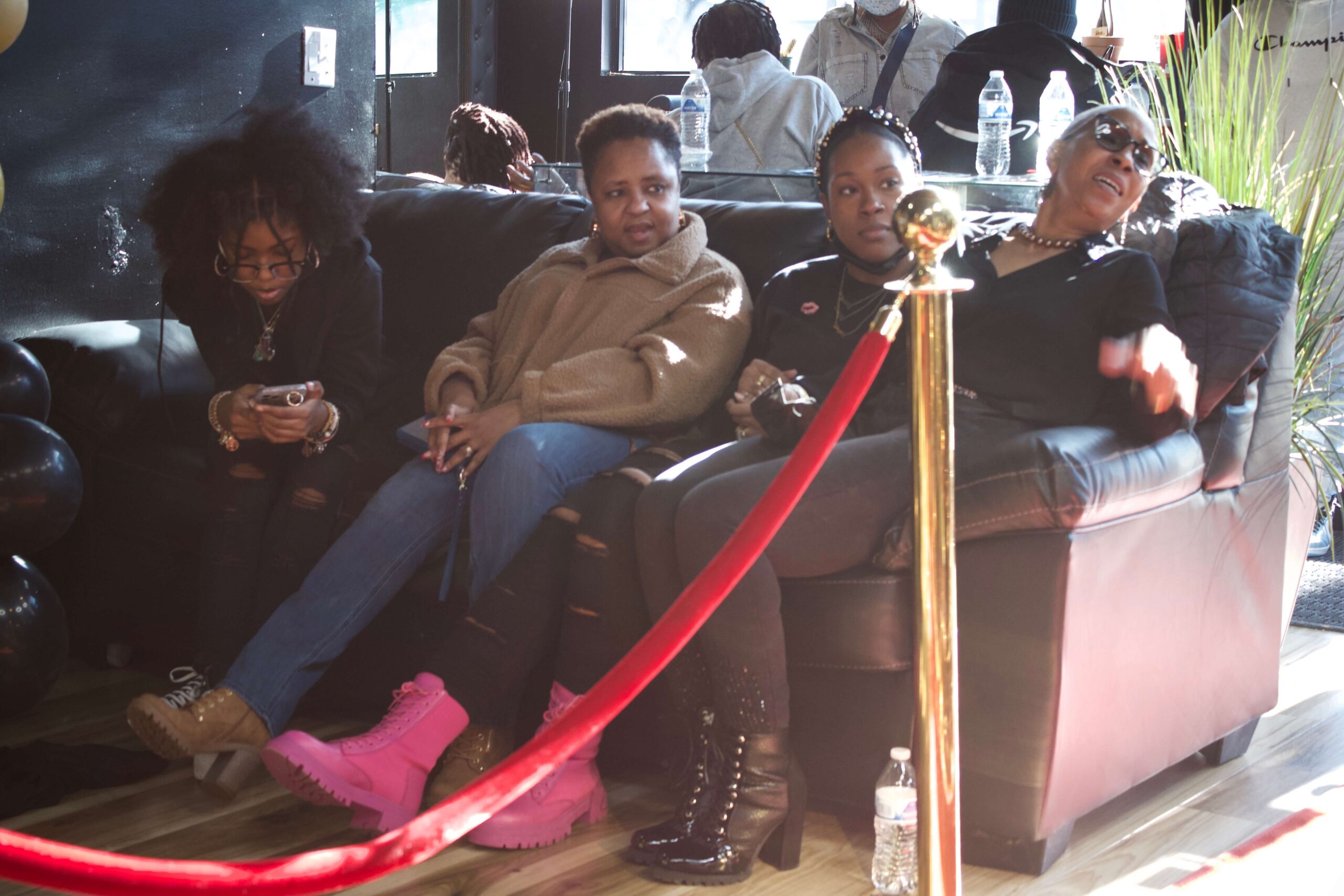 Women on a couch in TruFades Barbershop in Richmond, VA